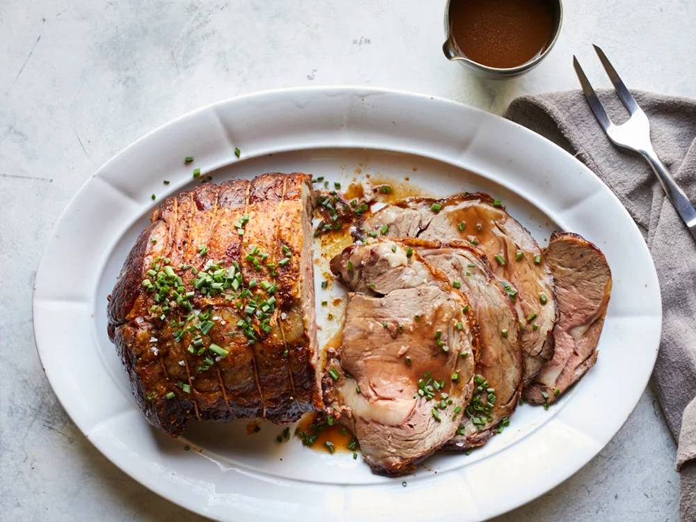 https://www.savoryonline.com/app/uploads/recipes/125224/perfect-prime-rib-with-red-wine-jus.jpg