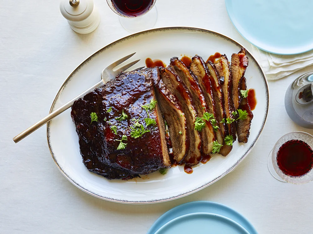 https://www.savoryonline.com/app/uploads/recipes/167049/slow-cooker-brisket-with-red-wine-glaze.jpg